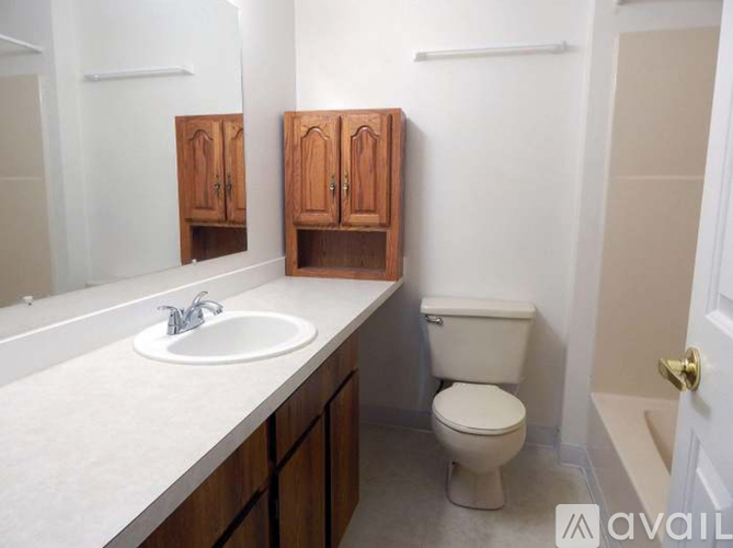 A bathroom with a toilet, sink, and medicine cabinet.