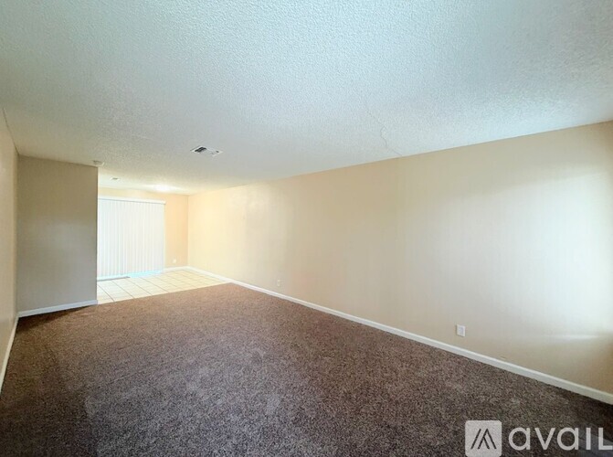 A room with carpeted floor and white walls.