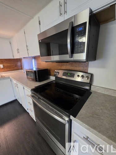 A modern kitchen with a stainless steel oven and microwave.