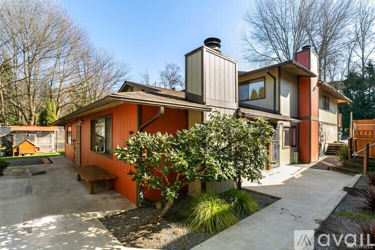 A house with a red and beige exterior is for sale.