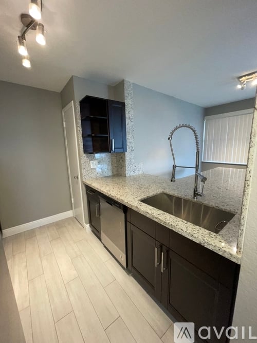 A kitchen with a sink and cabinets.