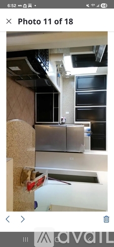 A kitchen with a stainless steel refrigerator and a white countertop.