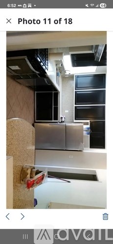 A kitchen with a stainless steel refrigerator and a white countertop.