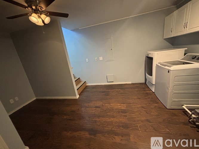 A kitchen area with a fan and a dishwasher.