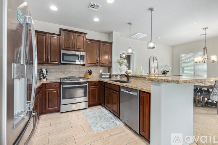 A kitchen with wooden cabinets and stainless steel appliances.