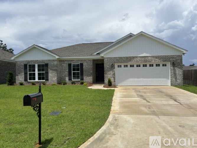A house with a garage and a driveway in front.