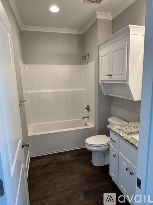 A small bathroom with a toilet, sink, and bathtub.