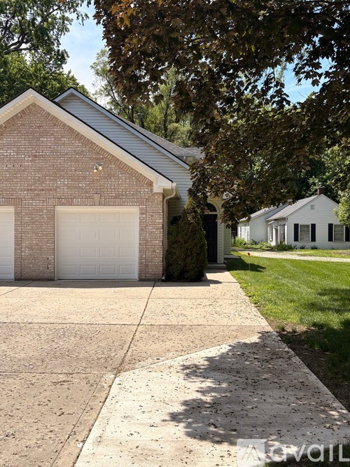 A house with a brick facade and a white garage door.