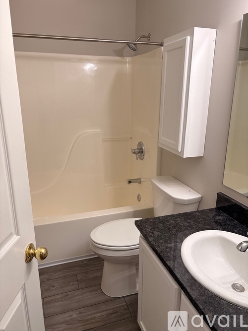 A bathroom with a toilet, sink, and shower.