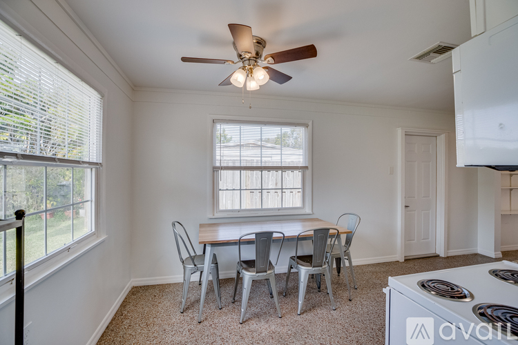 A dining room with a table and chairs.