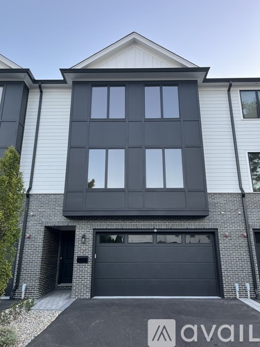 A modern house with a black garage door.