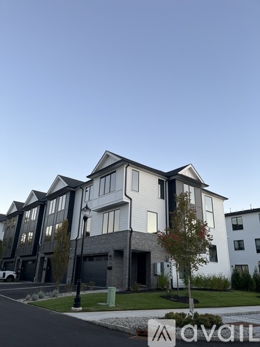 A modern two-story house with a white and black exterior.