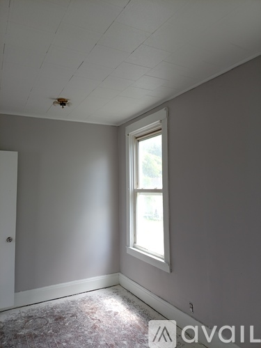 A room with a window and a door.