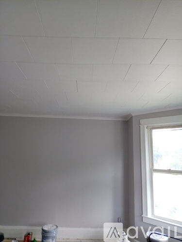 A room with a window and a white ceiling.