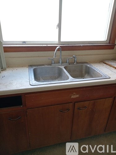 A kitchen sink with a window above it.