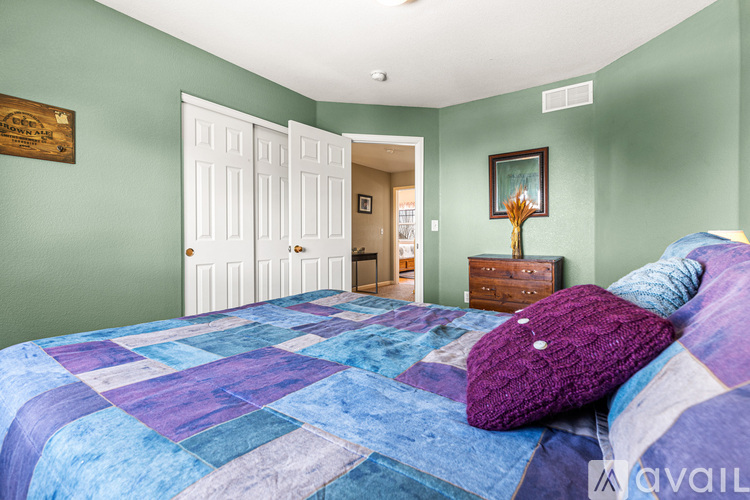 A bedroom with a bed and a dresser.