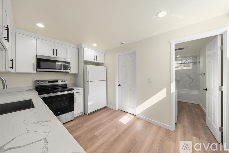 A kitchen with white cabinets and a drawing on the counter.