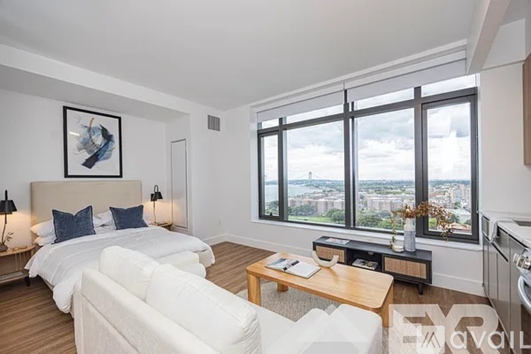 A bedroom with a large bed and a view of the city.