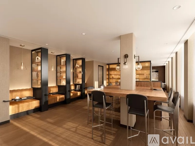 A modern dining room with a long table and chairs.