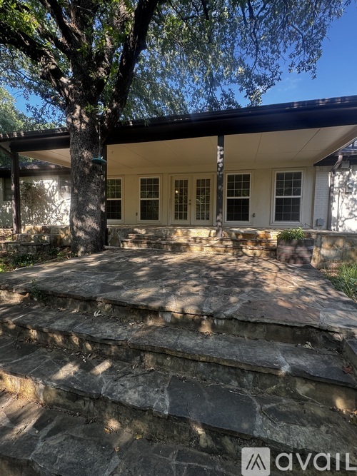 A house with a stone staircase leading to the front door.
