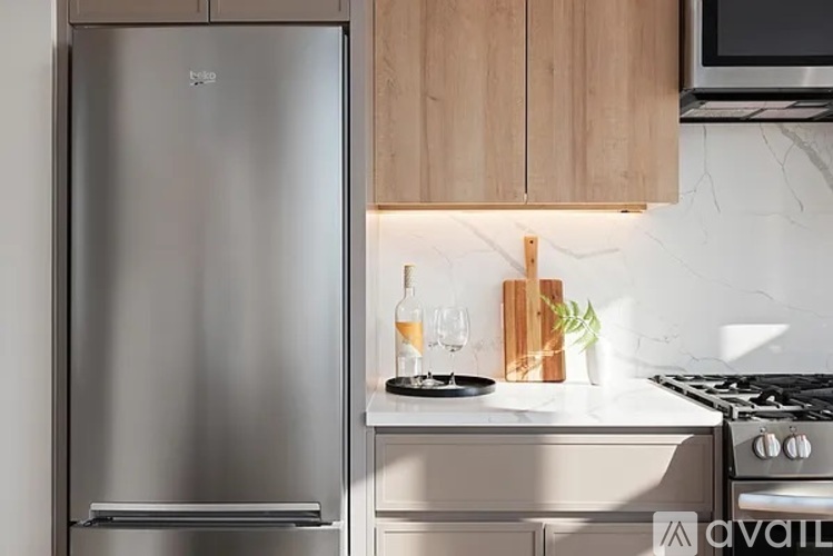 A modern kitchen with a stainless steel refrigerator and a wooden countertop.