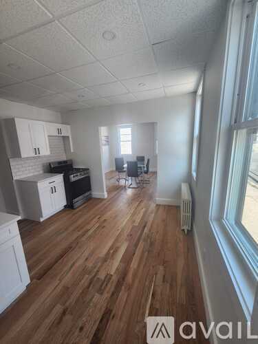 A room with wooden floors and white walls.