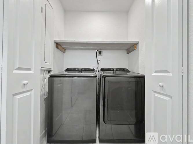 A kitchen with two ovens and white cabinets.