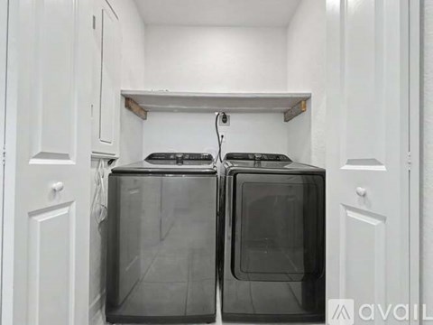 A kitchen with two ovens and white cabinets.