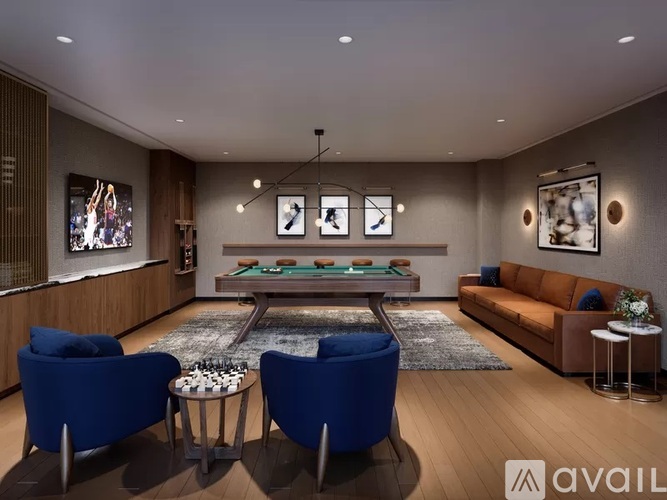A modern living room with a pool table and blue chairs.