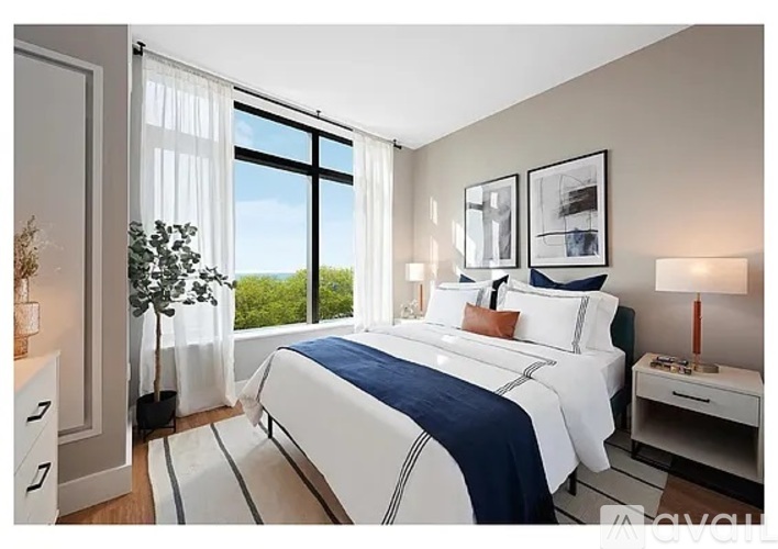 A bedroom with a large bed and a view of the ocean.