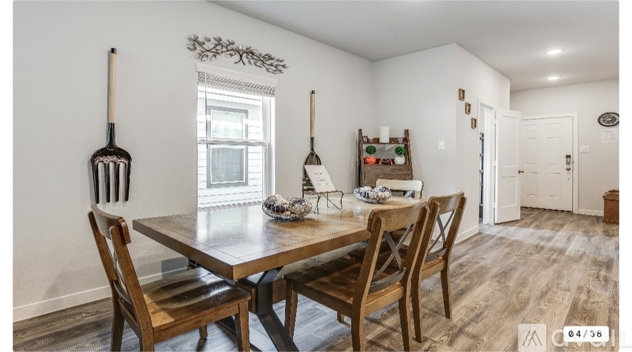 A dining room with a wooden table and chairs.