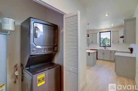 A kitchen with a microwave and oven built into a cabinet.