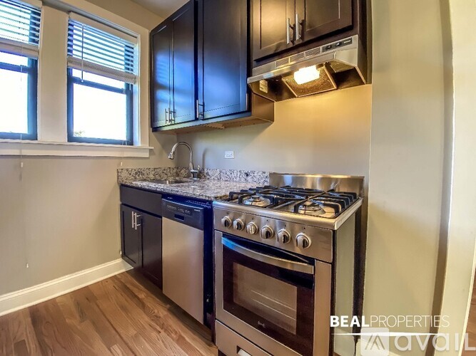A kitchen with a stove top oven and a microwave above it.