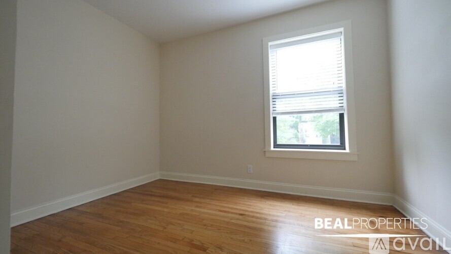 Empty room with wooden floors and a window.