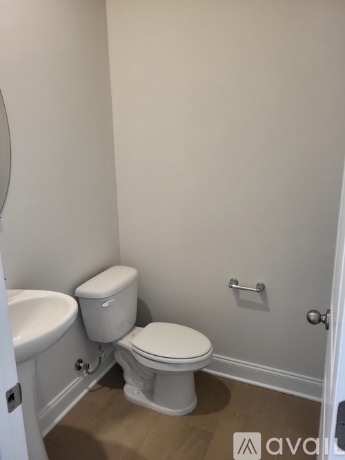 A white toilet is installed in a small bathroom.