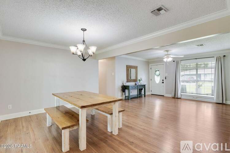 A dining room with a wooden table and benches.