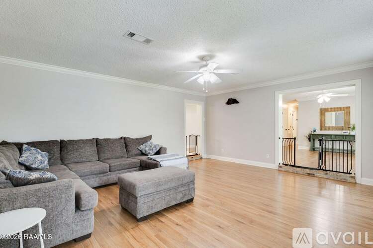 A living room with a grey sofa and a white table.