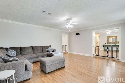 A living room with a grey sofa and a white table.