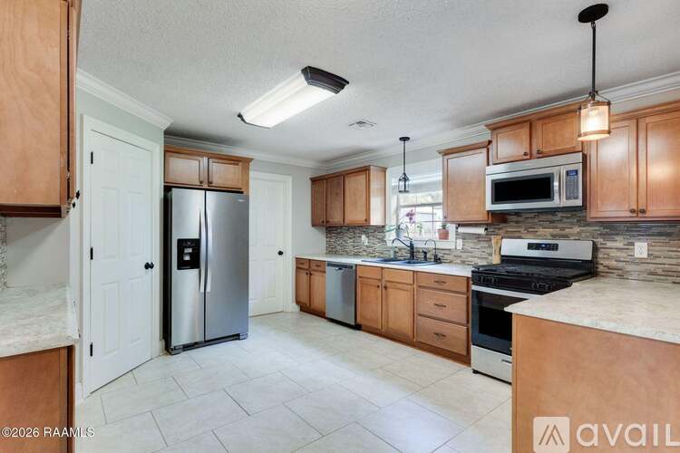 A kitchen with wooden cabinets and a granite countertop.