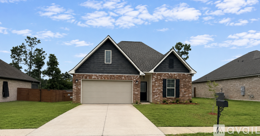 A house with a grey roof and a brick chimney.
