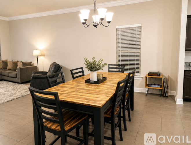 A dining room with a wooden table and chairs.