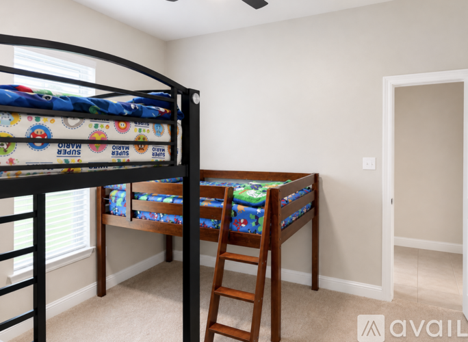A bedroom with a bunk bed and a wooden chair.