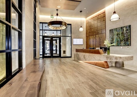 A modern interior with a wooden floor and a large chandelier.