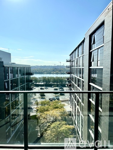 A view from a high-rise building looking out over a parking lot and other buildings.