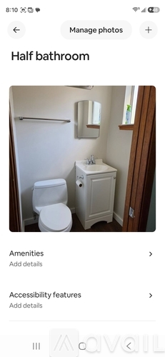 A white toilet and sink in a half bathroom.