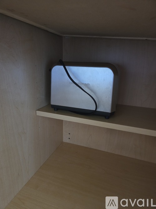 A small television is placed on a shelf.