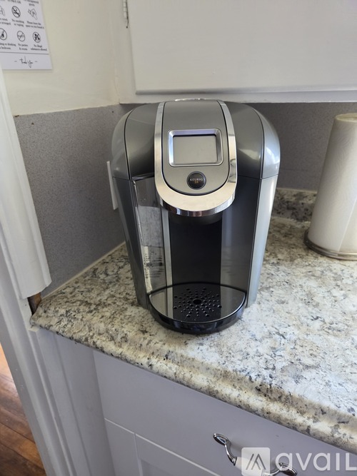 A coffee maker on a granite countertop.
