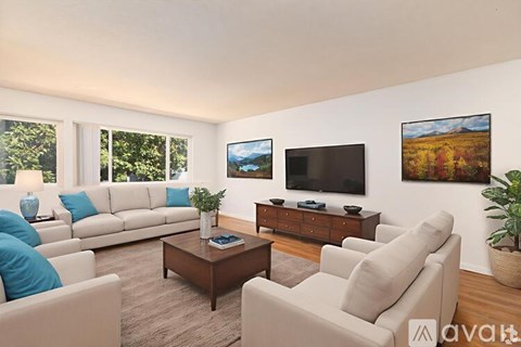 A living room with a couch, chairs, and a television.
