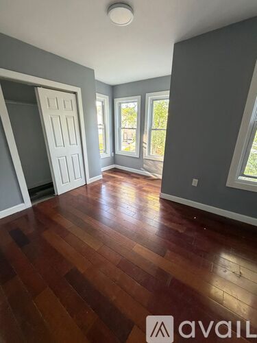 A room with wooden floors and a white door.