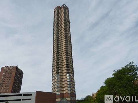 A tall building with a zigzag pattern on the side.